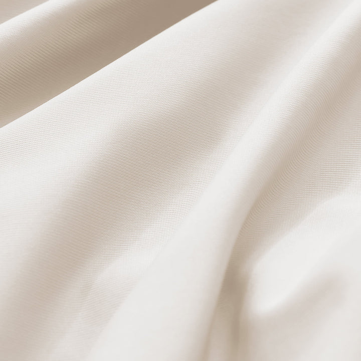 Cream-beige cooling pillowcase fabric close-up, fine breathable weave texture