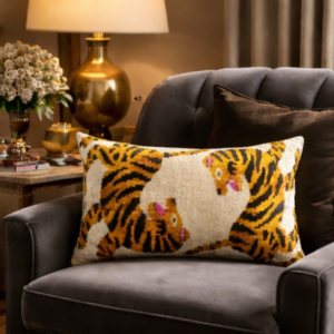Tiger motif ikat throw pillow cover on chair, cream base with yellow and pink accents