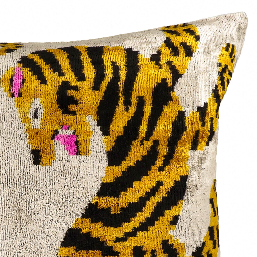 Close-up corner view of tiger ikat throw pillow cover, cream with yellow curved lines