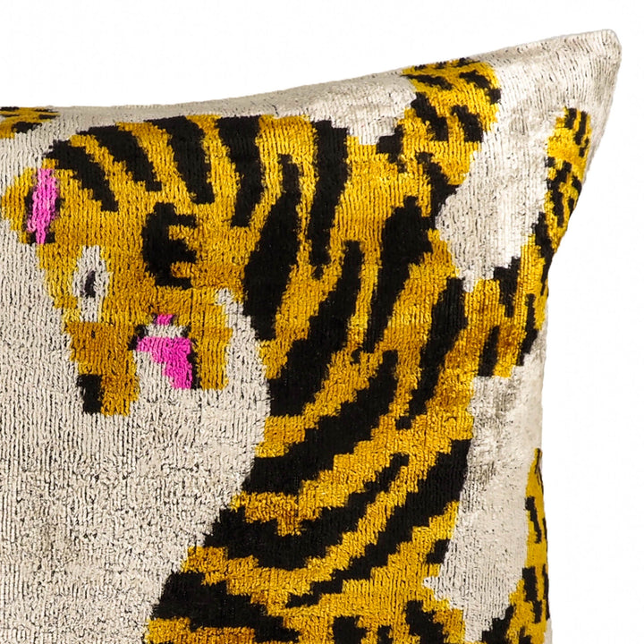 Close-up corner view of tiger ikat throw pillow cover, cream with yellow curved lines