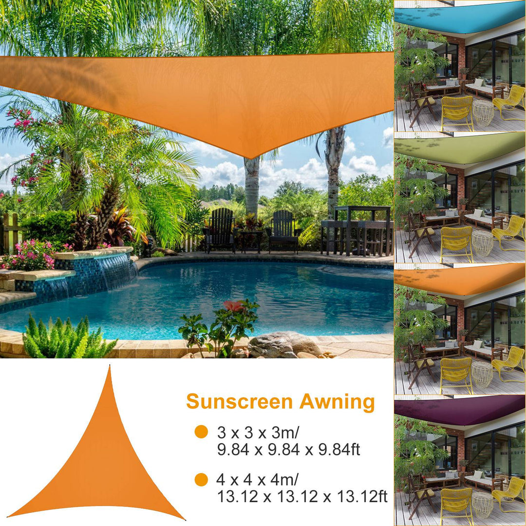 Orange triangular shade sail awning stretched outdoors