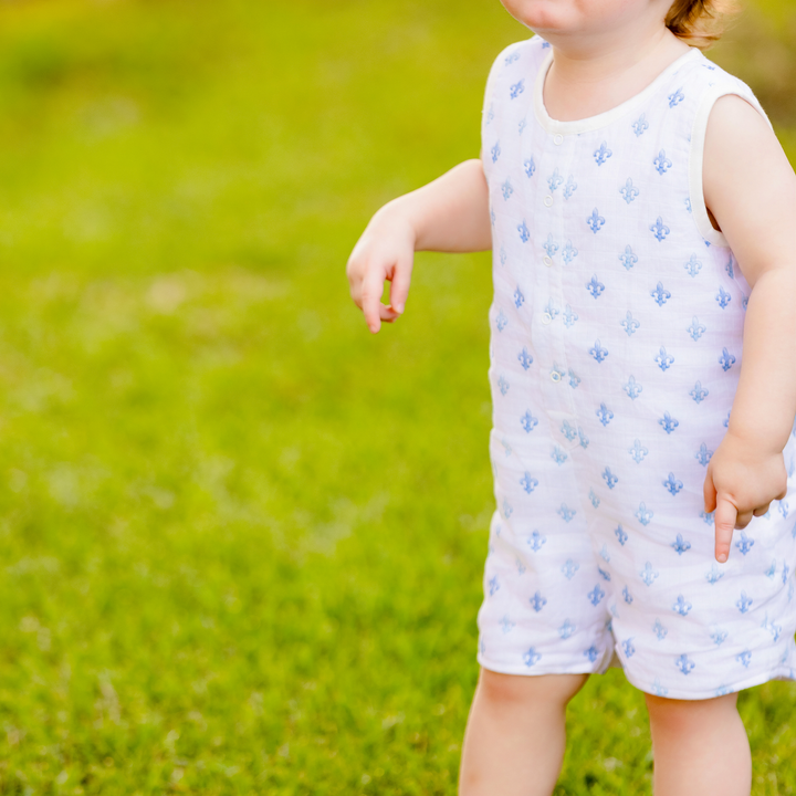 Sleeveless organic muslin shortall worn by child, light blue anchor print
