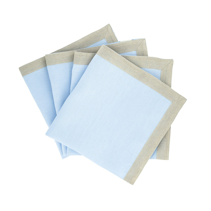 Light blue linen napkins with beige border trim, folded stack