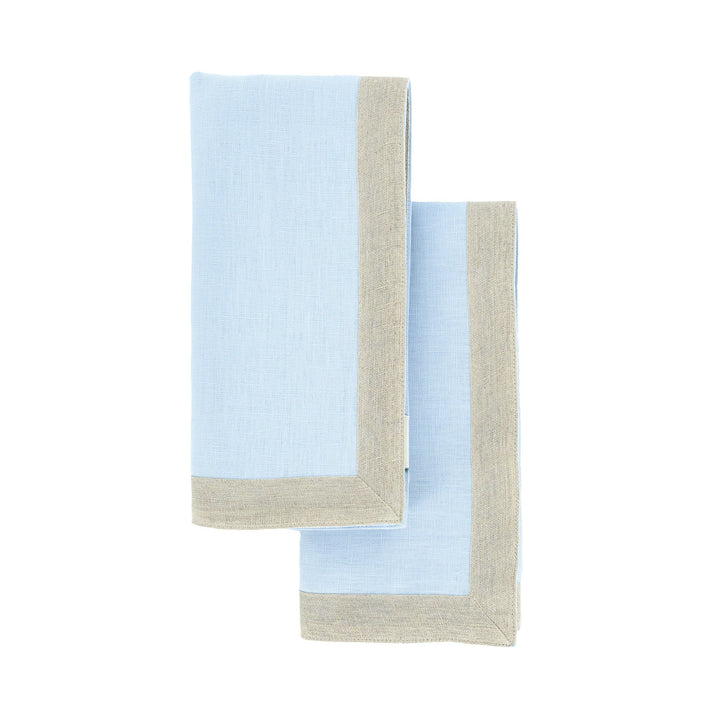 Light blue linen napkins with beige border trim, overlapping folds