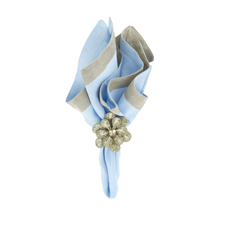 Light blue linen napkin with beige border trim, tied with gold flower