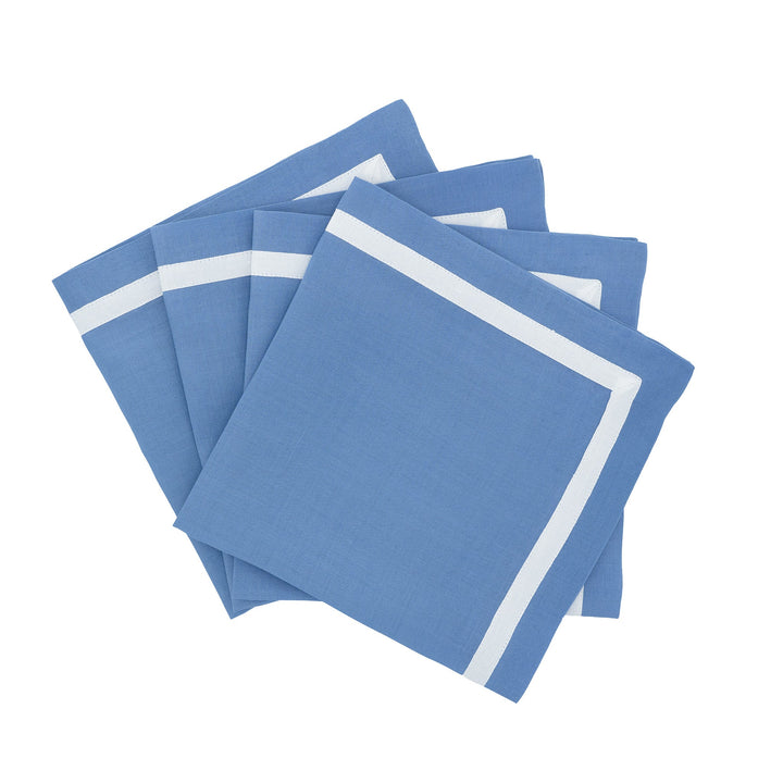 Blue linen napkins with white border, folded and stacked