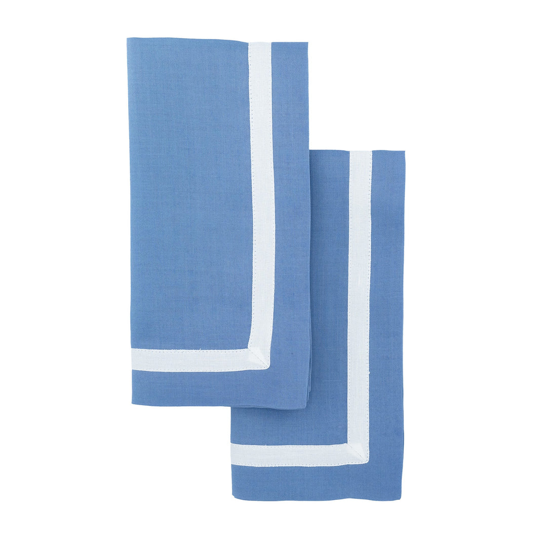 Blue linen napkins with white borders, two folded and stacked