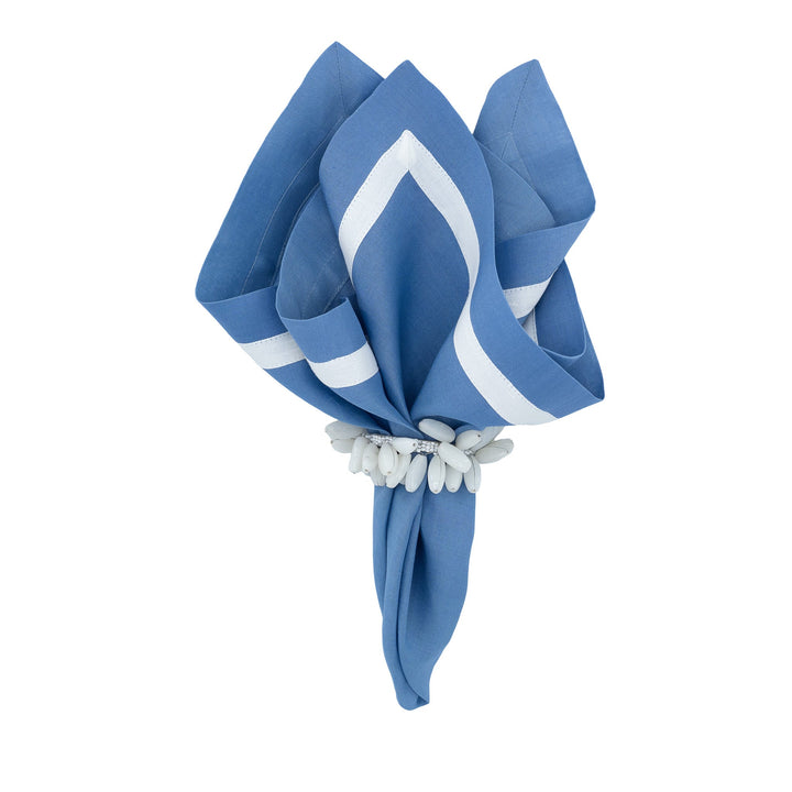 Blue linen napkins with white borders, bundled with a light tie wrap