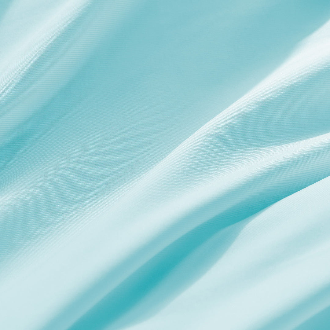 Light blue cooling pillowcase fabric close-up with smooth woven texture