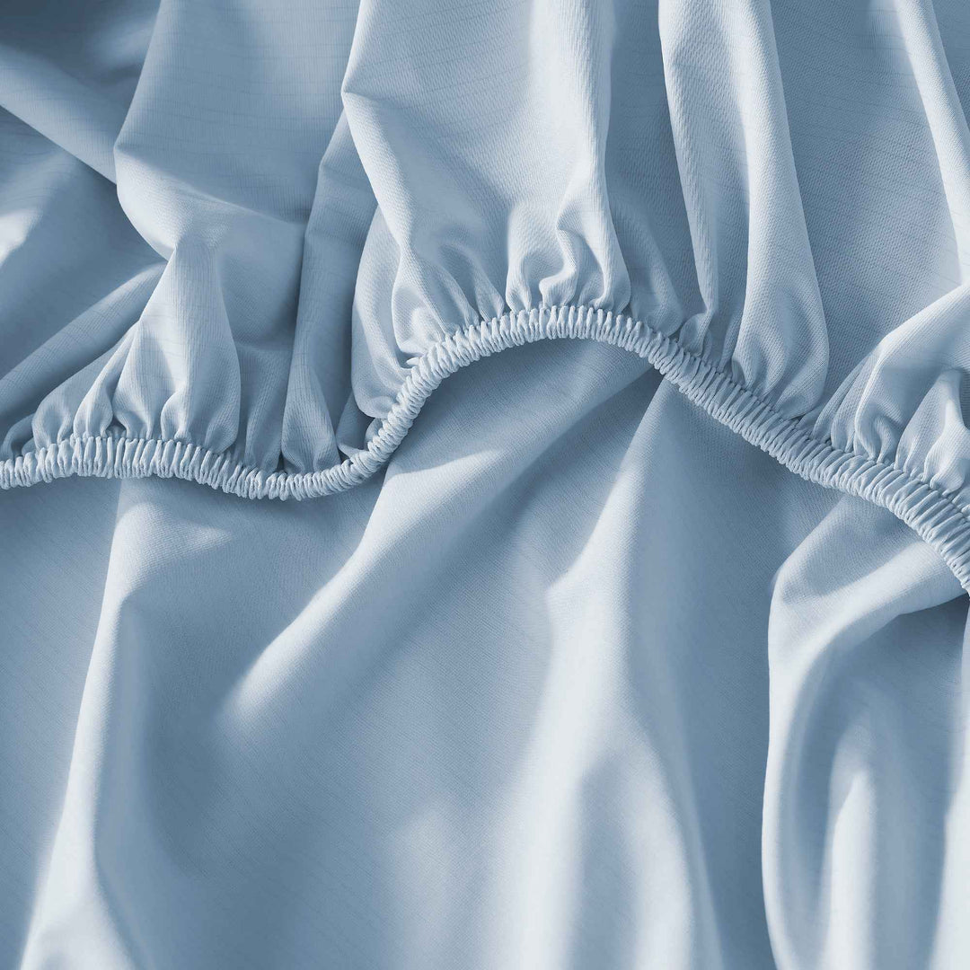 Light blue sheet set corner with elasticized hem and gathered edge stitching