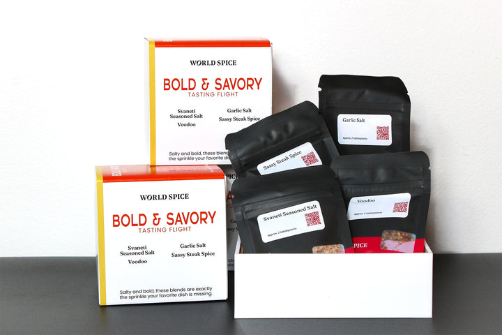 Spice tasting flight sampler with labeled sachets in black bags and cardboard boxes
