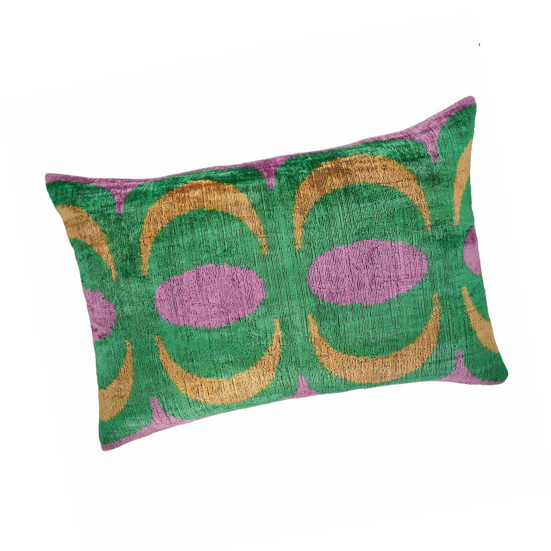 Silk velvet ikat throw pillow with green, purple, and gold geometric motifs
