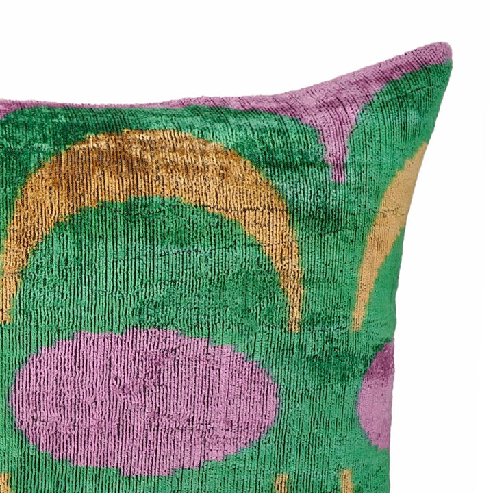 Silk velvet ikat throw pillow corner detail with green and gold arches on purple