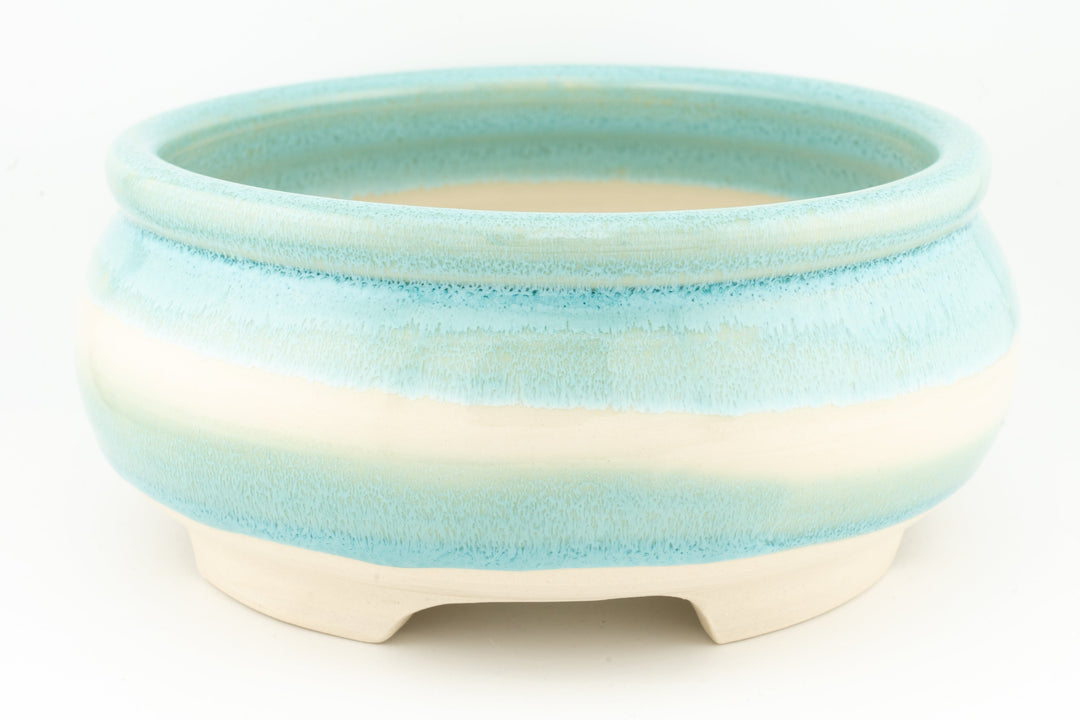 Ceramic bonsai pot in light blue-green glaze with smooth rim and three feet.