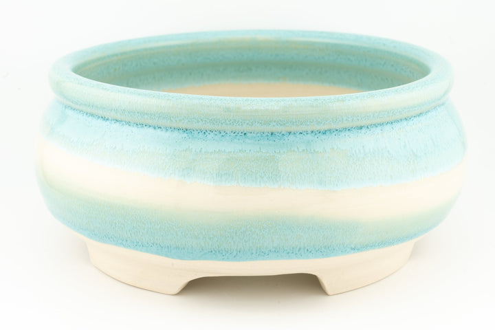 Ceramic bonsai pot in light blue-green glaze with smooth rim and three feet.