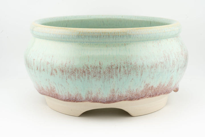 Ceramic bonsai pot in pale turquoise speckled glaze with three small feet.