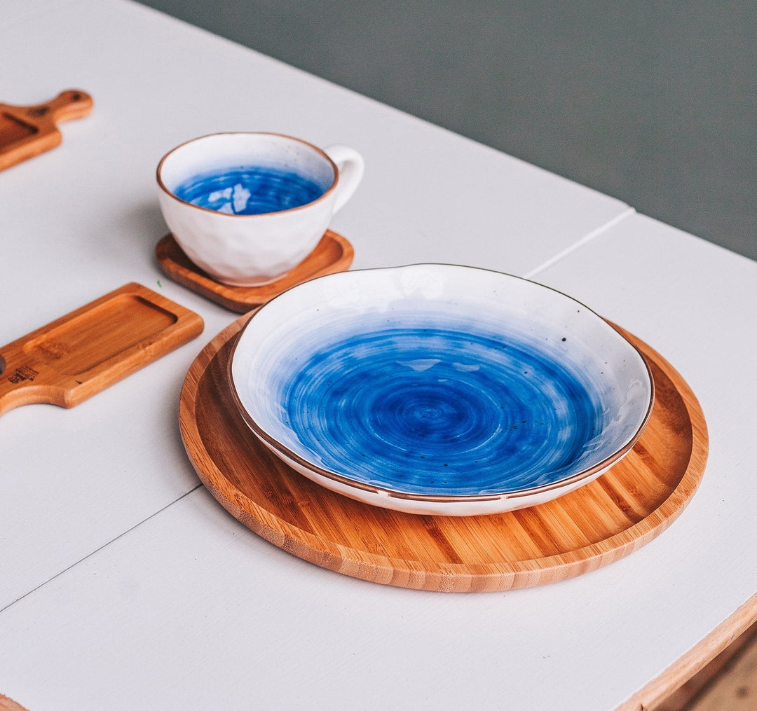 Square bamboo appetizer plates set with small bowls of food