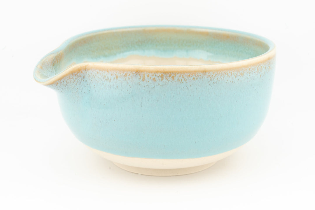 Light blue ceramic bowl with side spout and white interior
