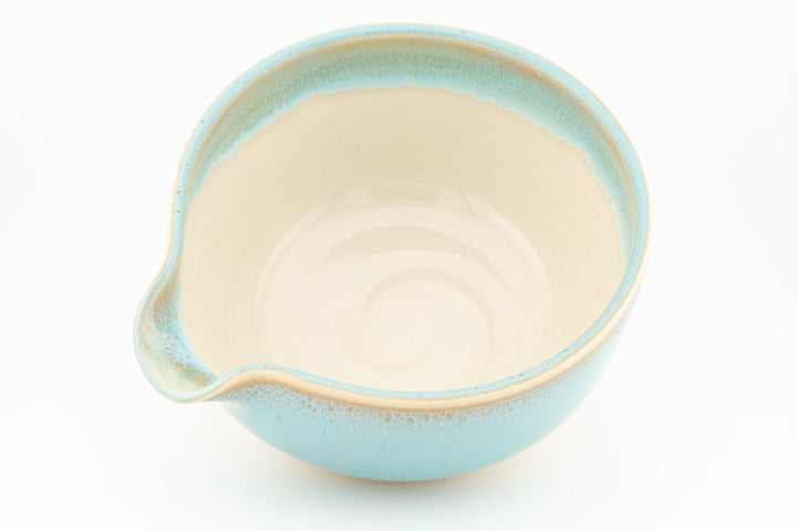 Turquoise ceramic bowl with side spout, cream interior