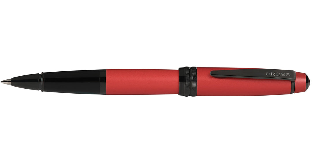 Matte red lacquer rollerball pen with black grip and clip, angled view