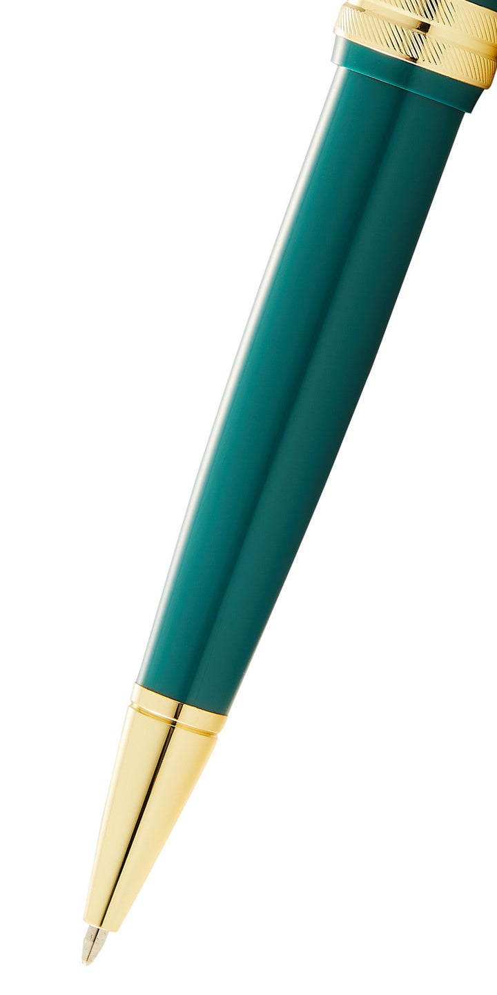 Green resin ballpoint pen with gold-tone tip and polished barrel