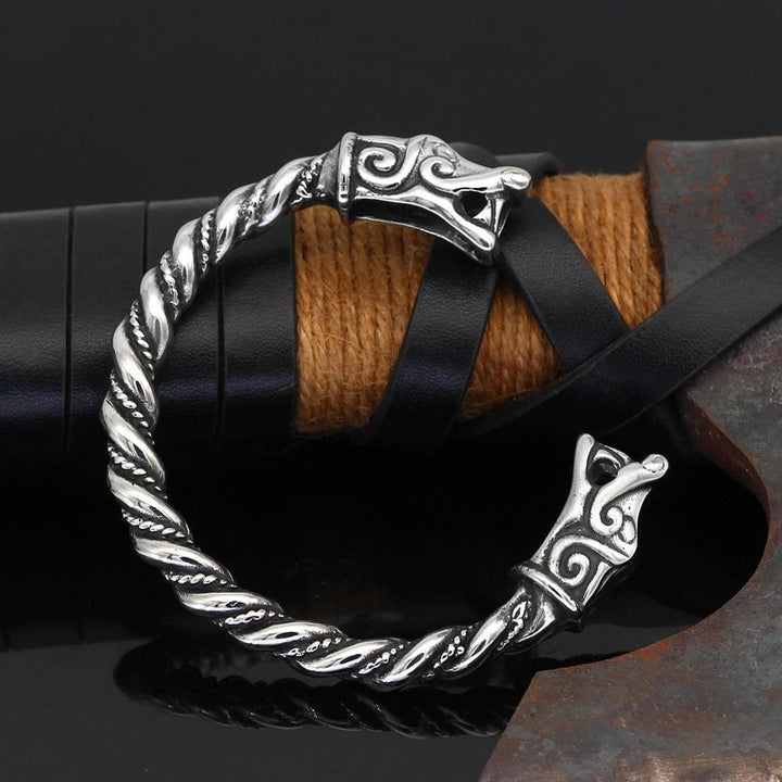 Stainless steel dragon bracelet with twisted band and engraved end charms on leather cuff