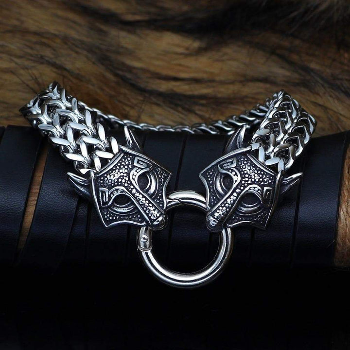 Wolf-head charm bracelet with chunky silver chain and circular ring clasp