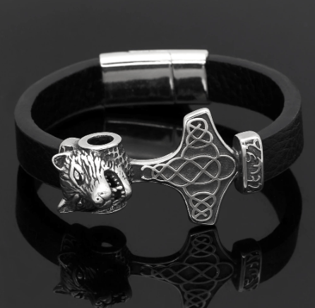 Black leather bracelet with silver wolf-head charm, Mjolnir symbol, and cuff rings