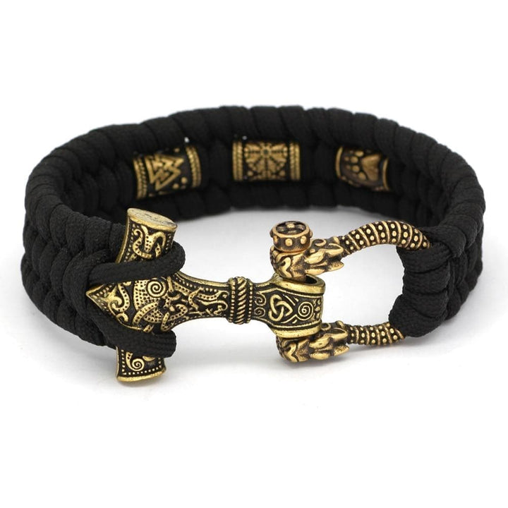 Black paracord bracelet with gold-toned hammer pendant and braided cord links