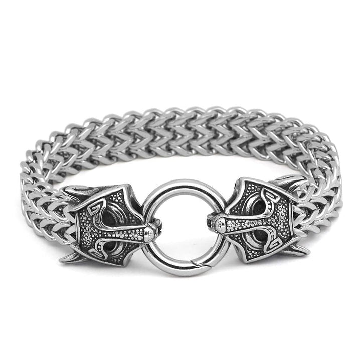 Stainless steel chain bracelet with circular clasp and wolf-head charms, silver-tone