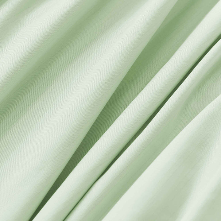 Close-up of light green cooling fabric with fine weave texture