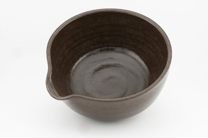 Stoneware bowl interior view with dark rim and glazed base