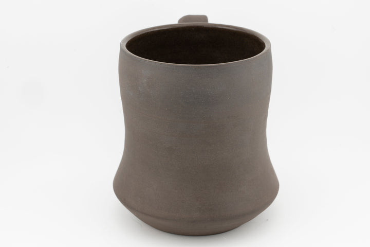 Curvy tall brown stoneware mug, wide rim and matte exterior