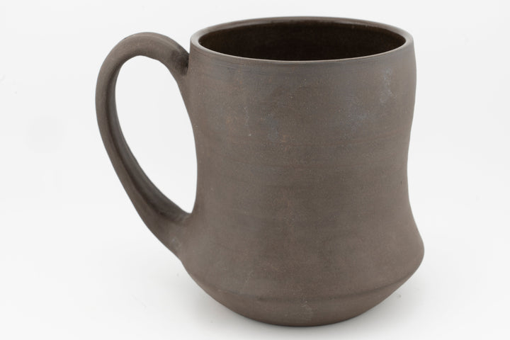 Curvy tall brown stoneware mug with C-shaped handle, front view