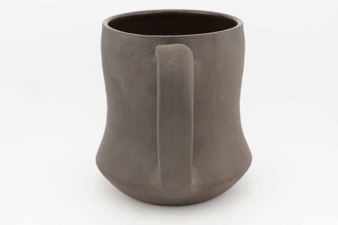 Curvy tall brown stoneware mug interior view, smooth rim and matte exterior