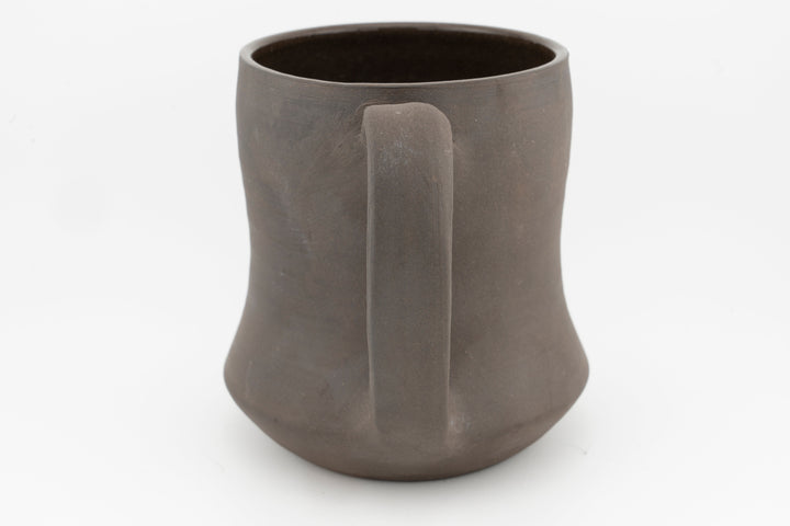Curvy tall brown stoneware mug interior view, smooth rim and matte exterior