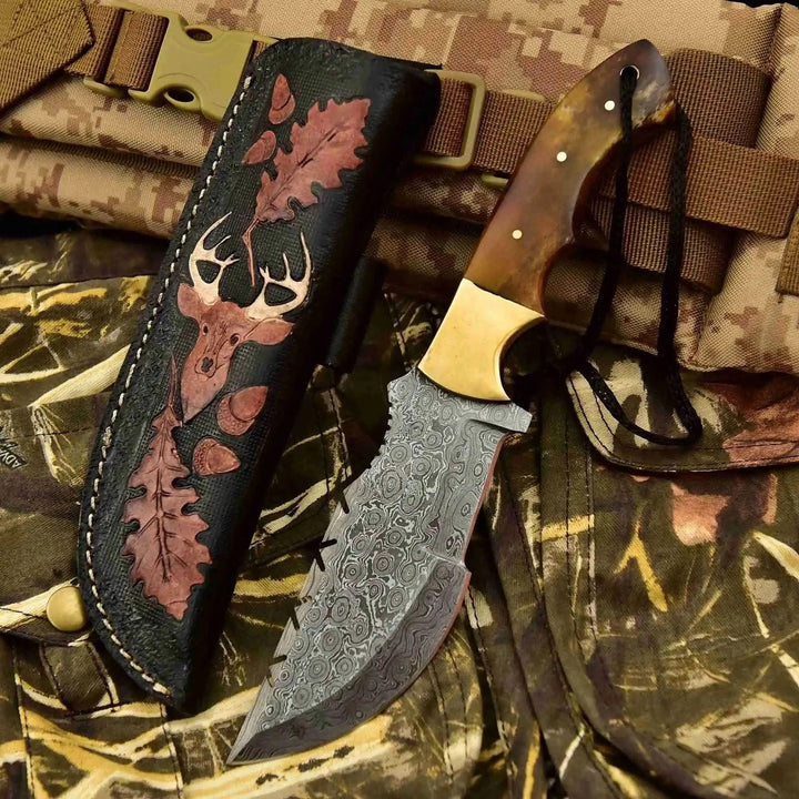Damascus survival knife with carved sheath and deer artwork, plus second knife with brown handle