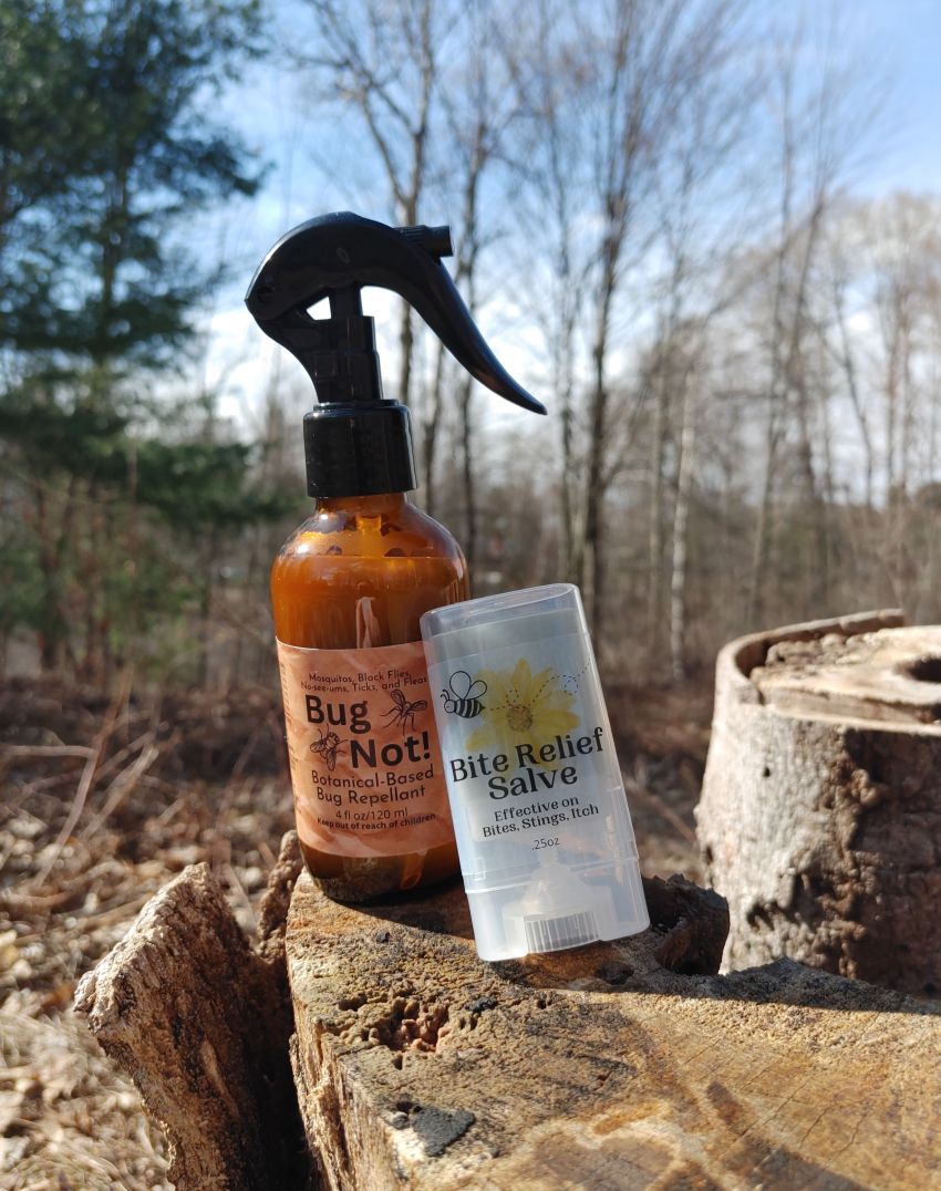 Insect bite relief salve clear balm container with label beside amber spray bottle