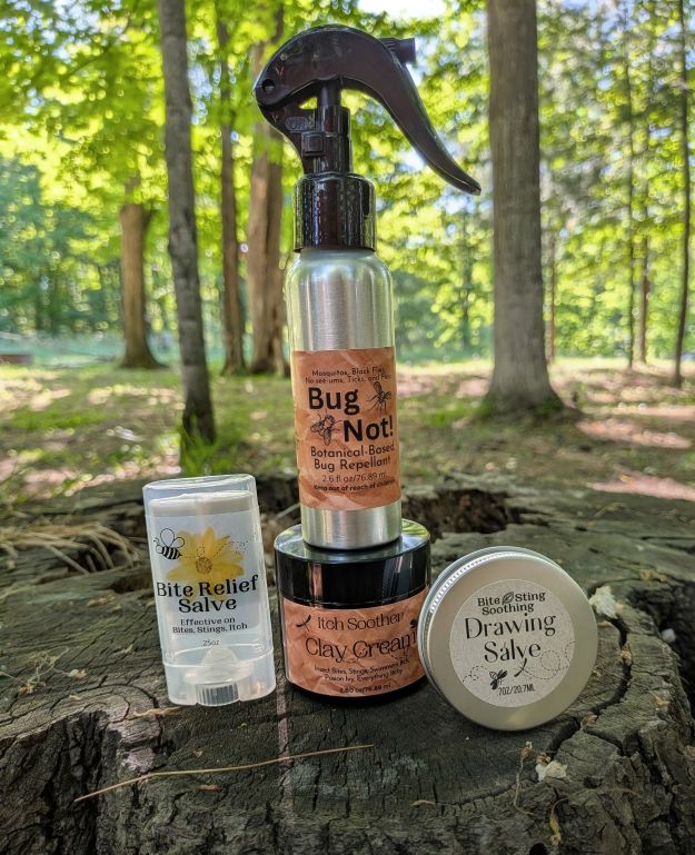 Activated charcoal drawing salve jar, round tin, and balm tube with protective spray