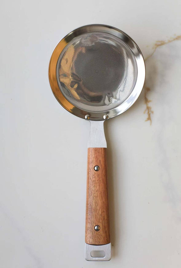 Round mesh strainer with silver mesh insert and wooden handle, hanging loop