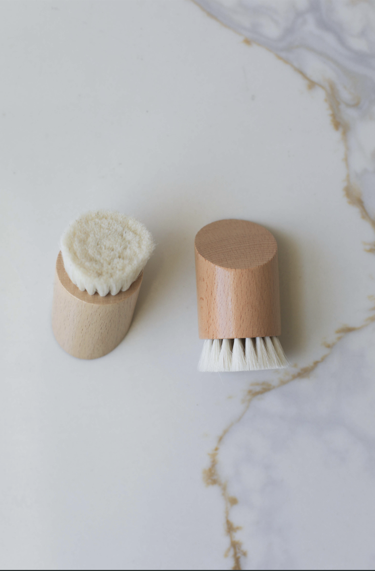 Two face brushes with wooden caps and white bristle heads