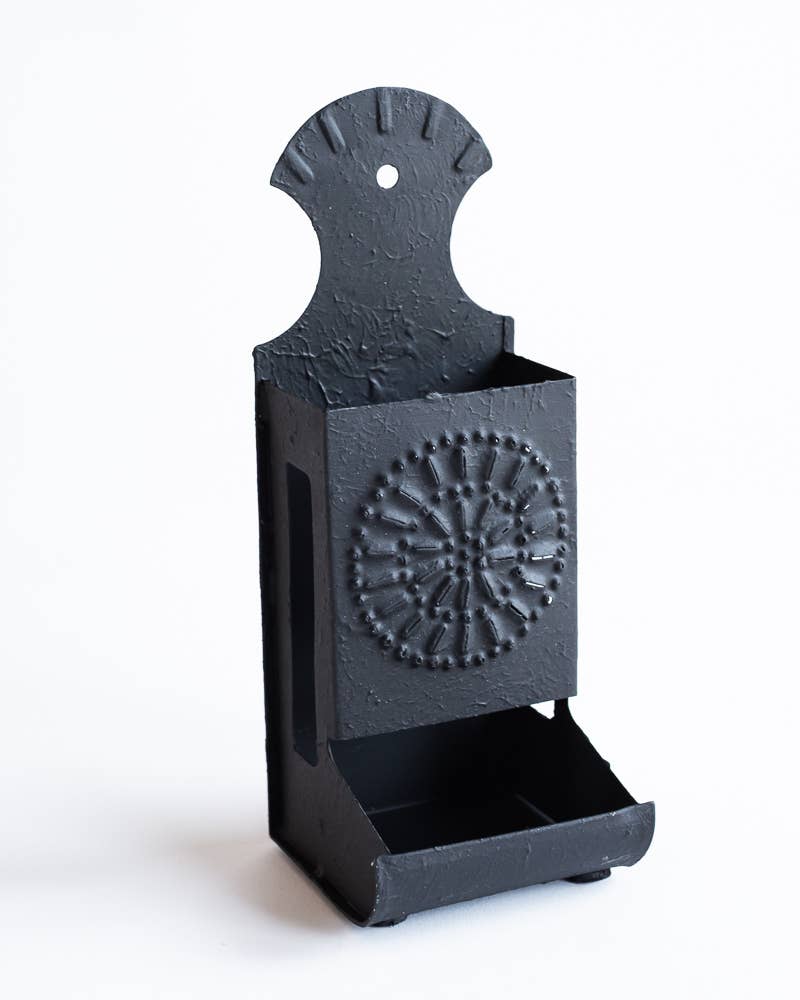 Dark metal matchbox holder with embossed circular medallion and front open match tray