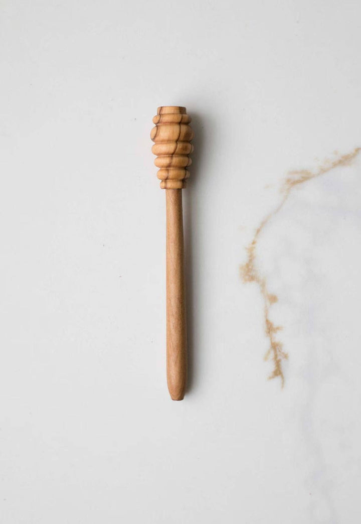 Olive wood honey dipper with ridged scoop end on wooden handle