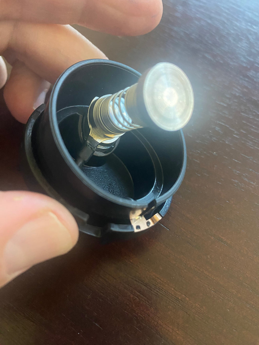 Blue calibration unit with exposed spring probe and white sensor head