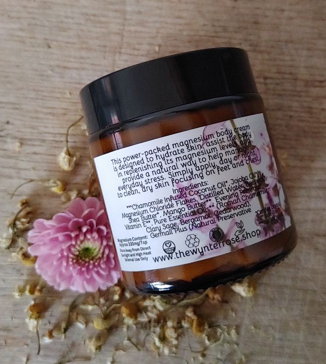 Magnesium body cream jar showing back ingredient panel with pink flower label