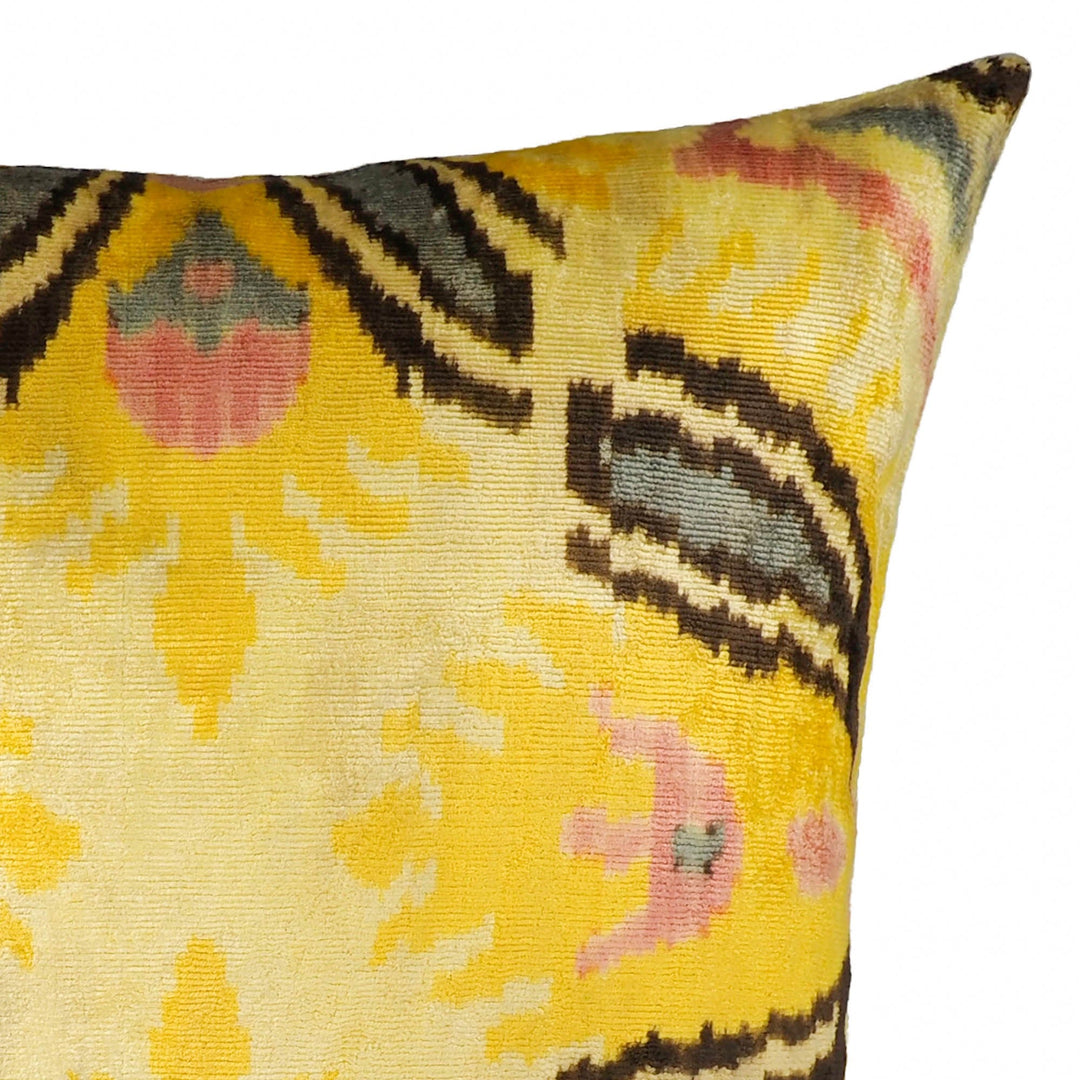 Silk velvet pillow cover close-up: yellow ground with pink dots and black ikat lines