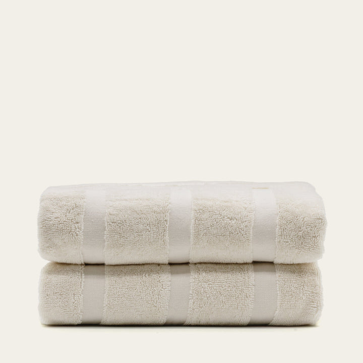 Ecru cotton towel stack, two folded towels with textured terry surface