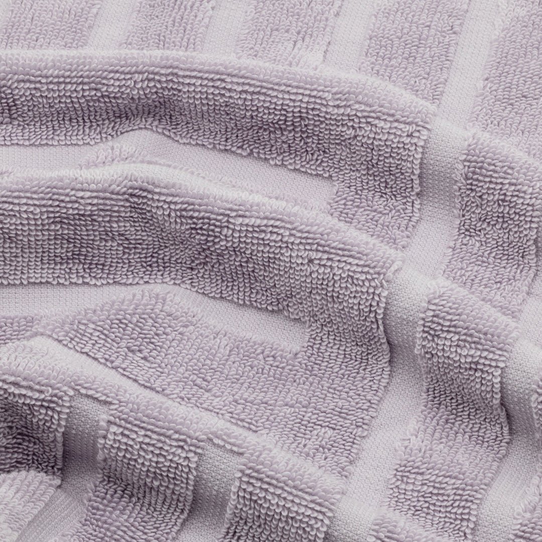 Lavender cotton towel close-up showing terry loops and subtle patterned bands