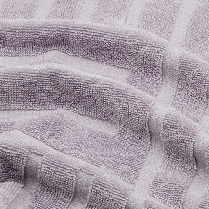 Lavender cotton towel close-up showing terry loops and subtle patterned bands