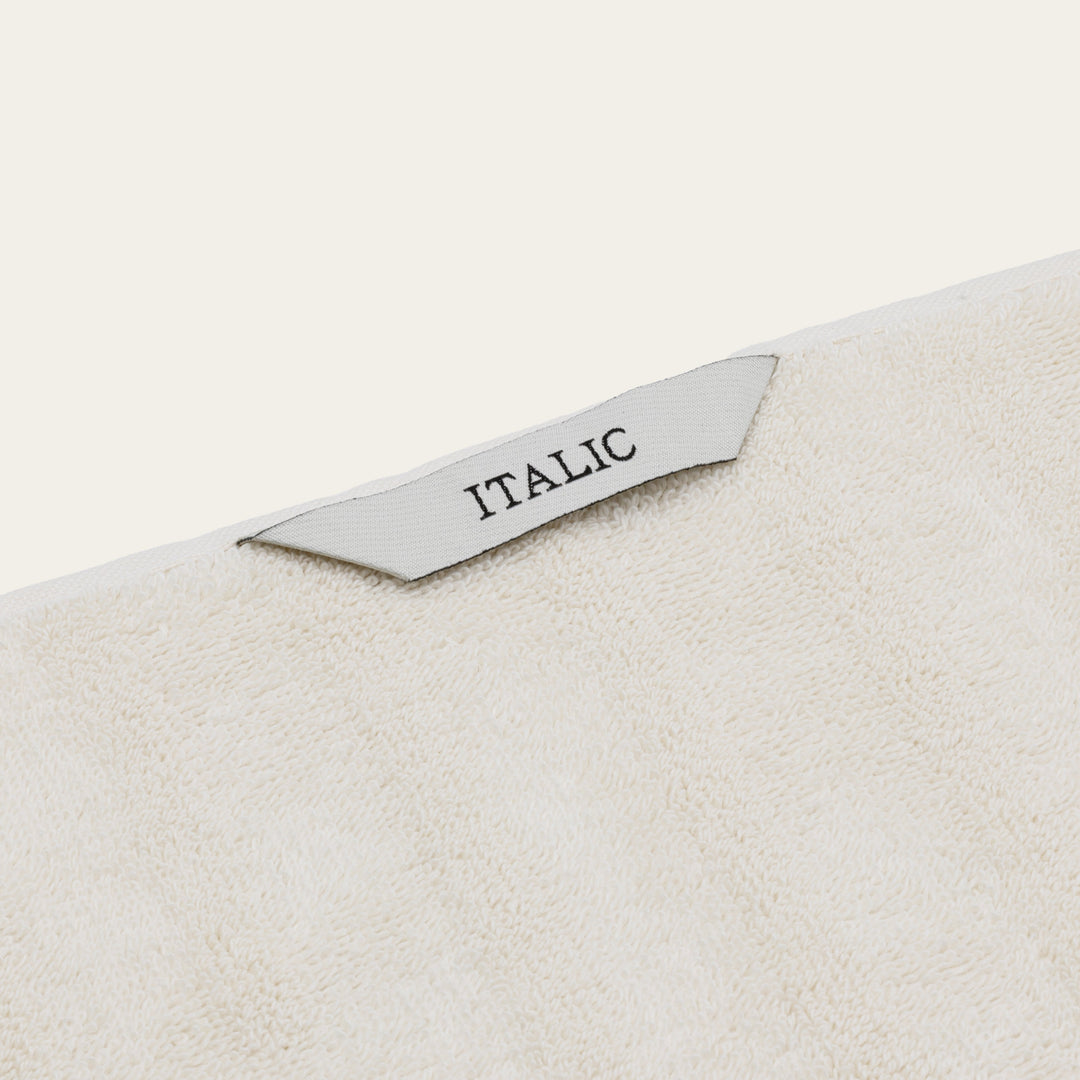 White cotton towel corner label reading “ITALIC”